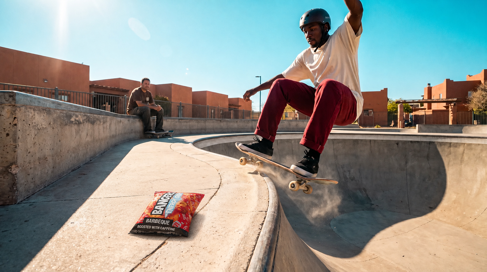 Skateboarder at a concrete bowl with a Barbeque Energy Chips bag lying on the ledge